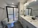 Modern bathroom with a walk-in shower, double vanity, and black fixtures at 82 Asher Pointe Way, Benson, NC 27504