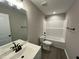Bathroom featuring modern vanity, toilet and shower with tub at 82 Asher Pointe Way, Benson, NC 27504