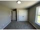 Bedroom showcasing plush carpet, double door closet and entrance to another room at 82 Asher Pointe Way, Benson, NC 27504