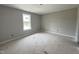 Bright, empty bedroom featuring a window providing lots of natural light and neutral paint on the walls at 82 Asher Pointe Way, Benson, NC 27504