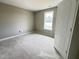 Cozy bedroom with a window providing natural light, neutral paint, and an open doorway for easy access at 82 Asher Pointe Way, Benson, NC 27504