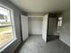 This carpeted bedroom has an open closet with a white rod at 82 Asher Pointe Way, Benson, NC 27504
