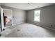 A bedroom featuring base molding, window, and fresh paint at 82 Asher Pointe Way, Benson, NC 27504