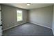 Well-lit bedroom featuring neutral walls, plush carpet, and a window offering a pleasant view at 82 Asher Pointe Way, Benson, NC 27504