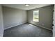 Comfortable bedroom with plush carpet and window allowing plenty of natural light at 82 Asher Pointe Way, Benson, NC 27504