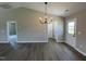 Dining room with chandelier lighting, hardwood floors, and multiple doors at 82 Asher Pointe Way, Benson, NC 27504