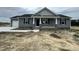 Charming single-story home features a gray exterior, stone accents, and a cozy front porch at 82 Asher Pointe Way, Benson, NC 27504