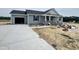 New home featuring an attached garage, a concrete driveway, and gray vinyl siding at 82 Asher Pointe Way, Benson, NC 27504