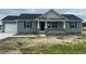Charming single-story home features a gray exterior, stone accents, and a cozy front porch at 82 Asher Pointe Way, Benson, NC 27504
