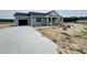Charming gray home with a black roof, a driveway, and under-construction landscaping at 82 Asher Pointe Way, Benson, NC 27504