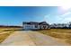 Inviting home featuring white siding, black shutters, and a long driveway at 82 Asher Pointe Way, Benson, NC 27504