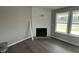 Bright living room showcases a modern fireplace with shiplap accent wall and a large window at 82 Asher Pointe Way, Benson, NC 27504
