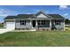 Charming single-story home featuring gray siding, stone accents, and an attached garage at 82 Asher Pointe Way, Benson, NC 27504