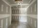 Hallway under construction featuring raw walls and concrete floors, ready for final touches and finishes at 82 Asher Pointe Way, Benson, NC 27504