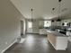 Modern kitchen boasts white cabinetry, granite countertops, stainless appliances, and a central island at 82 Asher Pointe Way, Benson, NC 27504
