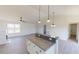 Open-concept kitchen featuring an island with granite countertop and stainless steel appliances at 82 Asher Pointe Way, Benson, NC 27504