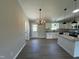Kitchen and dining room area featuring white cabinets, granite countertops, and stainless steel appliances at 82 Asher Pointe Way, Benson, NC 27504