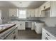 Stylish kitchen showcasing granite countertops, white cabinets, new flooring, and lots of natural light at 82 Asher Pointe Way, Benson, NC 27504