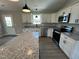 Modern kitchen with white cabinets, granite countertops, and stainless steel appliances at 82 Asher Pointe Way, Benson, NC 27504
