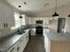 Modern kitchen features granite countertops, stainless appliances, and white cabinetry at 82 Asher Pointe Way, Benson, NC 27504