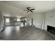 Open-concept living room features wood-look floors, a fireplace, and flows into the adjacent kitchen at 82 Asher Pointe Way, Benson, NC 27504