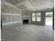 Unfinished living room with a fireplace, large windows, and natural light at 82 Asher Pointe Way, Benson, NC 27504