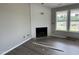 Cozy living room with fireplace and large windows offering natural light and outdoor views at 82 Asher Pointe Way, Benson, NC 27504