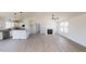 Open living room with vaulted ceiling, fireplace, and views to the kitchen and bathroom at 82 Asher Pointe Way, Benson, NC 27504