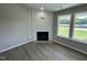 Cozy living room featuring a fireplace, hardwood floors, and lots of natural light at 82 Asher Pointe Way, Benson, NC 27504