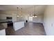 Spacious living room open to the kitchen, featuring modern lighting and a cozy fireplace at 82 Asher Pointe Way, Benson, NC 27504