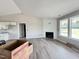 Spacious living room with vaulted ceilings, fireplace, and abundant natural light from large windows at 82 Asher Pointe Way, Benson, NC 27504