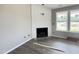 Cozy living room with fireplace and large windows offering natural light and outdoor views at 82 Asher Pointe Way, Benson, NC 27504