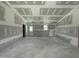 Spacious living room under construction, featuring raw walls, concrete floors, and natural light from the door and windows at 82 Asher Pointe Way, Benson, NC 27504