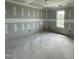 Spacious room under construction with a large window for natural light and raw walls ready for final touches at 82 Asher Pointe Way, Benson, NC 27504