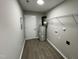 Utility room with water heater, overhead light, vinyl floor, and wire shelving at 82 Asher Pointe Way, Benson, NC 27504