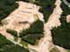 An aerial view shows a construction site getting ready for new residential building in a wooded area at 8717 Wardle Ct, Raleigh, NC 27616