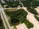 An aerial photo shows land being cleared for new construction near roads and surrounded by a heavily wooded area at 8717 Wardle Ct, Raleigh, NC 27616