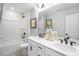 Modern bathroom featuring double sinks, white cabinetry, framed mirrors, and modern black fixtures at 8717 Wardle Ct, Raleigh, NC 27616