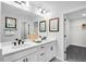 Modern bathroom with dual sinks, white cabinetry, framed mirrors, and stylish fixtures at 8717 Wardle Ct, Raleigh, NC 27616