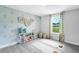 Versatile bonus room with yoga mats, stylish wallpaper, and a window overlooking a green area at 8717 Wardle Ct, Raleigh, NC 27616