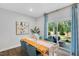 Bright dining room with wood table, blue chairs, and sliding glass doors to patio at 8717 Wardle Ct, Raleigh, NC 27616