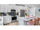 Charming kitchen with white cabinets, modern appliances, an island with seating, and decorative accents at 8717 Wardle Ct, Raleigh, NC 27616