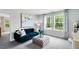 Cozy living room with a plush blue sofa, patterned pillows, and a view of the outdoors at 8717 Wardle Ct, Raleigh, NC 27616