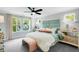 Comfortable main bedroom with light gray walls, large windows, and a luxurious upholstered headboard at 8717 Wardle Ct, Raleigh, NC 27616