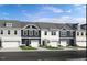 Charming townhome exteriors with a mix of light and dark facades and attached garages at 8717 Wardle Ct, Raleigh, NC 27616