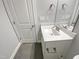 Bathroom features a sink with marble countertop, a mirror, and gray tile floors at 95 Cinnamon Teal Way, Youngsville, NC 27596