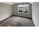 Cozy bedroom with carpet flooring and a window overlooking the neighborhood at 95 Cinnamon Teal Way, Youngsville, NC 27596
