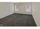 Empty bedroom with neutral walls, carpet and large window at 95 Cinnamon Teal Way, Youngsville, NC 27596