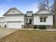 Charming two-story home with a two-car garage, stone accents, and a beautifully landscaped front yard at 95 Cinnamon Teal Way, Youngsville, NC 27596