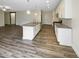 Open-concept kitchen featuring granite countertops, a center island with sink, and stainless steel appliances at 95 Cinnamon Teal Way, Youngsville, NC 27596
